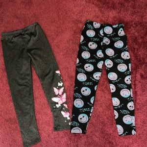 Two pair of stretch pants with graphics for girls size 5-6.